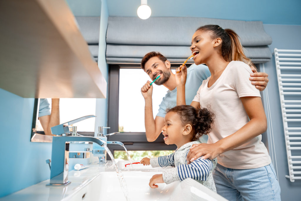 family brushing teeth together